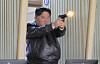 North Korean leader Kim Jong-un fires a pistol at a shooting range on March 11, during his inspection of a factory for light, portable weapons, in this photo published by the Korean Central News Agency on March 12. [YONHAP]