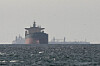 Cargo ships in the Gulf, near the Strait of Hormuz, as seen from northern Ras al-Khaimah, near the border with Oman’s Musandam governance, amid the U.S.-Israeli conflict with Iran, in United Arab Emirates, March 11. [REUTERS/YONHAP]