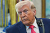 U.S. President Donald Trump listens to a reporter during the swearing in for U.S. Secretary of Homeland Security Markwayne Mullin in the Oval Office of the White House in Washington on March 24. [AP/YONHAP]