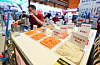 A participant demonstrates a vegetable-slicing machine at the 2026 Excellent Food Service Fair held at Coex in Gangnam District, southern Seoul, on April 21. [NEWS1]