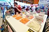 A participant demonstrates a vegetable-slicing machine at the 2026 Excellent Food Service Fair held at Coex in Gangnam District, southern Seoul, on April 21. [NEWS1]