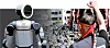 From left, the Atlas humanoid robot, and members of Hyundai Motor labor union stage a protest for wage increase in Ulsan on Sept. 3, 2025. [REUTERS/YONHAP]