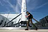 A man walks by a SpaceX Falcon 9 rocket displayed outside a SpaceX facility in Hawthorne, California, on March 26. [AFP/YONHAP]