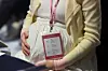 A pregnant woman touches her belly during an event marking Pregnant Women’s Day at the Fairmont Ambassador Seoul hotel in Yeouido, western Seoul, on Oct. 10, 2025. [NEWS1]