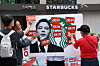 Members of a civic organization hold a protest against Shinsegae Group, the owner of Starbucks Korea, against the coffee franchise's ″Tank Day″ promotion, on May 27, in Gwanghwamun, central Seoul. Seen in the picture is the face of Chung Yong-jin, chairman of Shinsegae Group. [YONHAP]