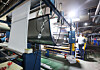 An employee climbs a ladder to a machine at a fabric company in Gyeonggi on March 31. [YONHAP]