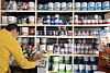 An employee organizes paint cans at a paint store in Seoul on March 25. [NEWS1]