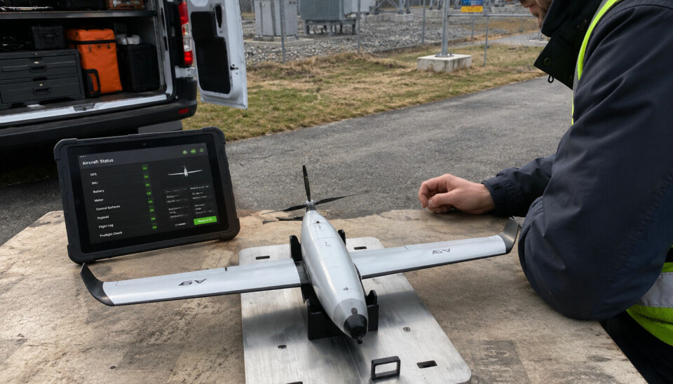 Worker operating a drone setup with a laptop beside a vehicle outdoors.