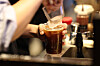 An employee puts ice cubes in a plastic cup filled with coffee at a cafe in Seoul on Dec. 18, 2025. [YONHAP]