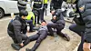 Police restrain Jang Il, a former People Power Party official, after he poured gasoline on himself and attempted self-immolation in protest of failing to receive a nomination in Yeouido, western Seoul, on March 3, 2024. [NEWS1]