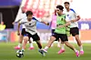 Lee Kang-in of the Paris Saint-Germain, left, vies for the ball with Vitinha during a training session ahead of the Champions League final soccer match between Paris Saint-Germain and Arsenal in Budapest, Hungary on May 29. [AP PHOTO/YONHAP]
