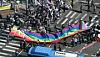 Participants in the 26th Seoul Queer Culture Festival carry a rainbow banner near Jonggak Station in Jongno District, central Seoul, on June 14, 2025.