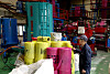 A worker inspects standardized garbage bags produced using recycled raw materials processed from vinyl instead of naphtha at a factory in Changwon, South Gyeongsang, on the morning of April 9. [YONHAP]