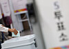 An eligible voter casts their vote for the local elections at a polling station in Dongjak District, southern Seoul, on June 3. [NEWS1]