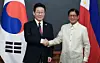 Korean President Lee Jae Myung, left, and Philippine President Ferdinand Marcos Jr. shake hands ahead of a bilateral summit at the presidential palace in Manila on March 3. [JOINT PRESS CORPS]