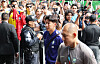 South Korean football players and staff arrive at a Guadalajara hotel amid photographers and security.