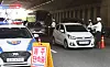 Police officers check drivers at a daytime sobriety checkpoint on a road in Suwon.