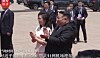 Chinese President Xi Jinping and hosts stand on a red-carpeted airport tarmac during a formal welcome in Pyongyang.