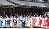 Foreign tourists wearing traditional Korean attire take photo at Gyeongbok Palace in central Seoul on April 16.