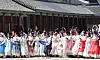 Foreign tourists wearing traditional Korean attire take photo at Gyeongbok Palace in central Seoul on April 16.