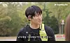 Man with a yellow backpack speaking outdoors in a park setting with SNL and Coupang Play logos visible.