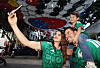 A family takes a selfie under a taegukgi installation on a pedestrian street in Zapopan, Mexico.