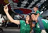 A family takes a selfie under a taegukgi installation on a pedestrian street in Zapopan, Mexico.