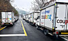 Coupang trucks are lined up on a street [JOONGANG ILBO]