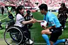 Kim Yun-ji, a double gold medalist in Nordic skiing at the 2026 Milan-Cortina Winter Paralympics, left, hands the match ball to referee Kim Jong-hyeok during the K League match between FC Seoul and Daejeon Hana Citizen at Seoul World Cup Stadium on April 18, two days before the Day of Persons with Disabilities. [FC SEOUL]