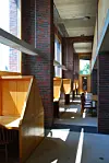 Individual study carrels, framed by brick, wood and natural light, create an atmosphere of quiet contemplation at a window-side reading area in the Exeter Library. [LIM YEONG-HWAN]