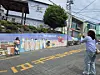 Tourists take a picture with a BTS mural at Gamcheon Culture Village in Busan on May 26. [JIN EUN-SOO]