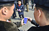 North Koreans read reports about the country's leader Kim Jong-un's arrival in Vietnam for his second summit with U.S. President Donald Trump by using a smartphone in Pyongyang, in this photo released by Kyodo on Feb. 27, 2019. [REUTERS/YONHAP]