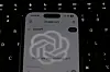 The OpenAI logo is reflected on the screen of a smartphone with the ChatGPT website displayed. [YONHAP]