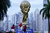 People pose for a photo with a giant replica of the FIFA World Cup trophy on Cinta Costera in Panama. [REUTERS/YONHAP]