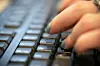A person types on a computer keyboard. [AP/YONHAP]