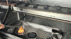 A person lights a charcoal briuette at GNC, a quick-light charcoal briquette factory located in Jecheon, North Chungcheong. [JOONGANG ILBO]