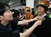Social workers put carnations on older people to mark Parent's Day at a community center in Busan on May 8. [NEWS1]