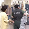 An SK hynix worker wearing a vest emblazoned with the company name appears in a parody scene on SNL, boasting about his wealth at a shop. [SCREEN CAPTURE]