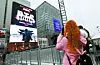 Fans take photos of a digital billboard featuring boy band BTS near Gwanghwamun Square in Jongno District, central Seoul, on March 18. [NEWS1]