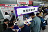 Job seekers fill out application forms at a job fair in Yeongdeungpo District, western Seoul on April 16. [NEWS1]