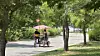 A couple rides on a family-sized bike at Yeouido Hangang Park on May 18. [WOO JI-WON]