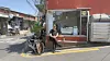 Park Sang-jun, the owner of cafe Elak, poses in front of his shop [WOO JI-WON]