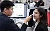 A foreign visitor, right, tests medical equipment at an exhibition held in southern Seoul on March 19.