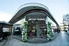 Olive Young store exterior in Los Angeles with glass storefront and balloon arches at the entrance.