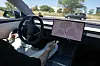 A car driver tests a Tesla's FSD (Full Self Driving) system on a road in Sabadell near Barcelona on May 26.
