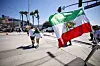 An Iran flag and a protest are seen outside the stadium in California on June 15.