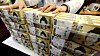 Bundles of 50,000 won ($33) bills are piled up in a commercial bank in central Seoul on Feb. 24.