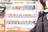 A cosmetics display in a Seoul store with shoppers browsing products in the foreground.