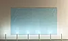 Light-blue fabric panel on a beige wall with a row of small lights along the floor.