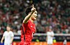South Korea player in red celebrates after scoring in a World Cup match.